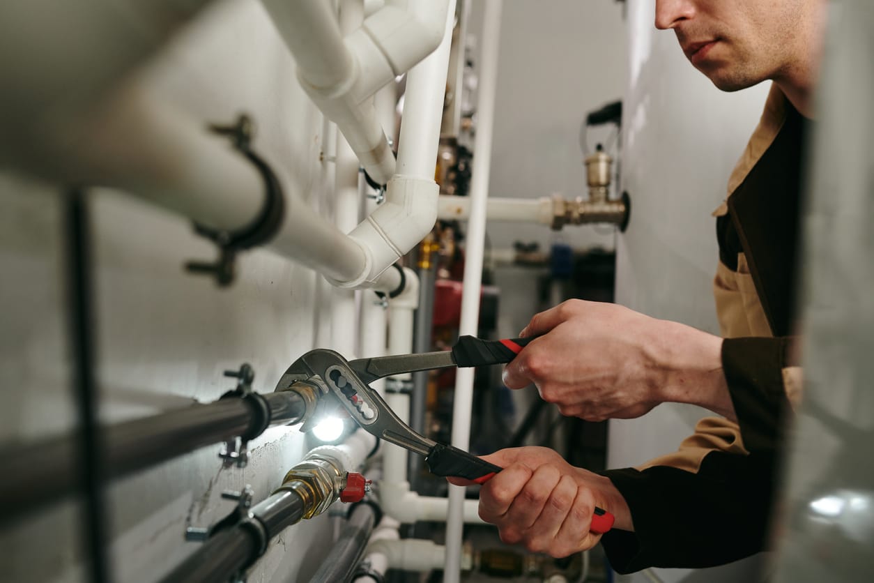 Plumbers maintaining commercial plumbing pipes in Ruskin