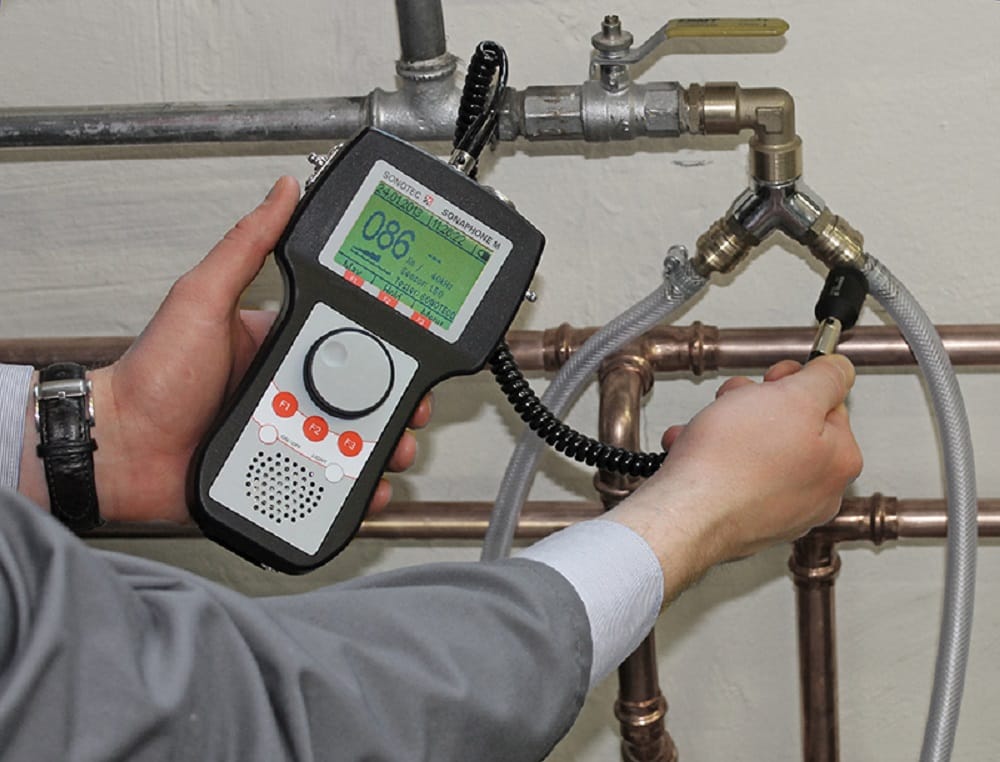 Plumber testing pipes with electronic leak detection equipment in Ruskin