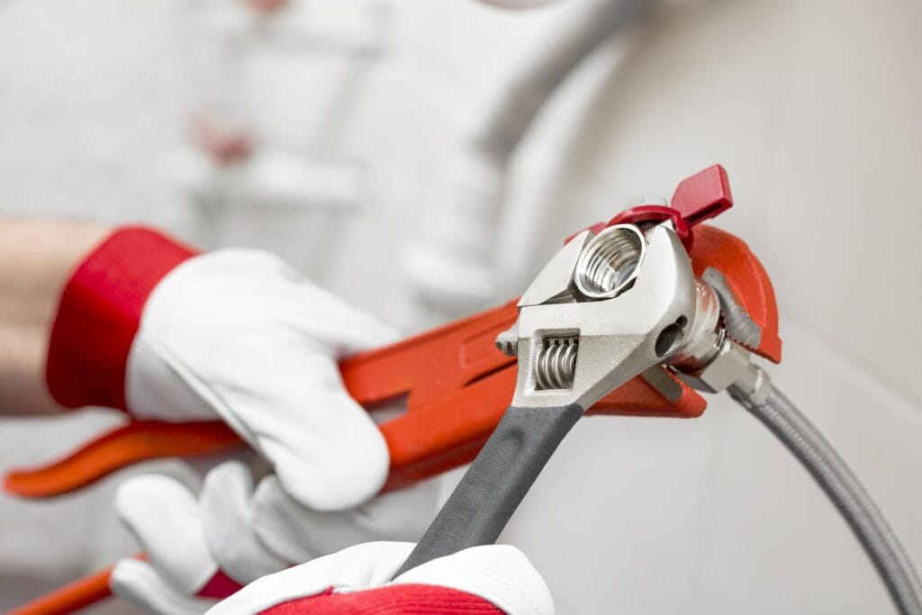 Plumber holding pipe wrenches for an emergency repair in Ruskin
