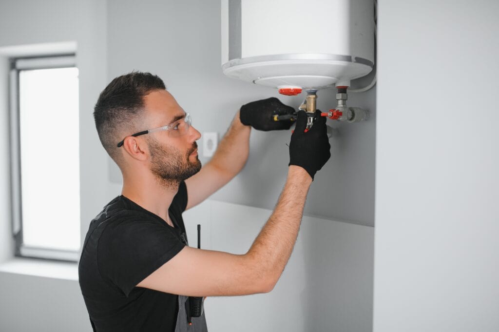 Technician performing water heater maintenance in Ruskin