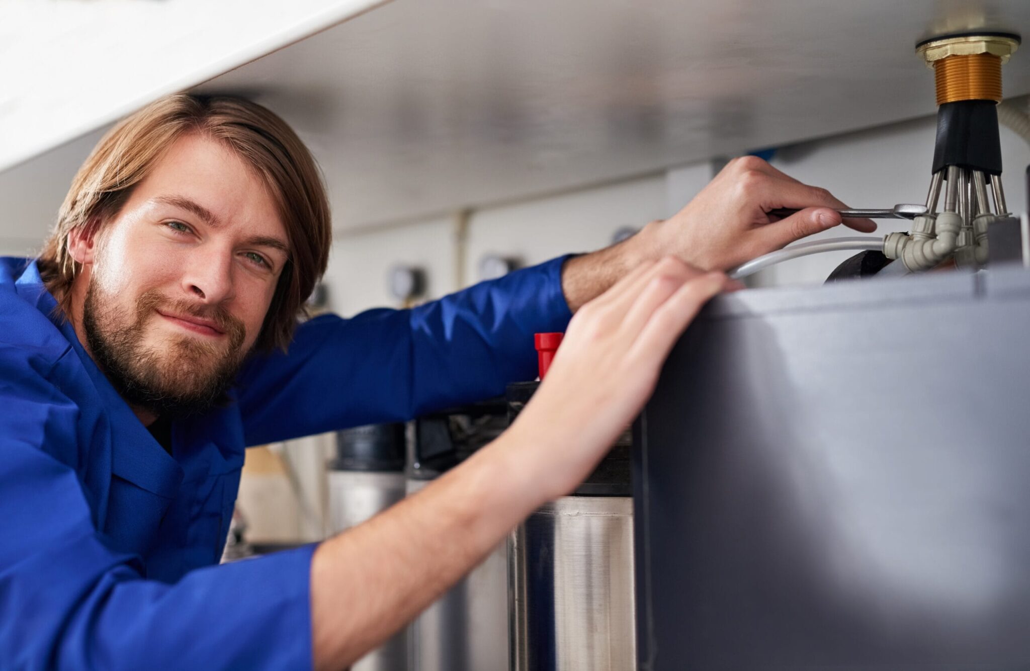 Technician servicing a residential water heater tank in Ruskin
