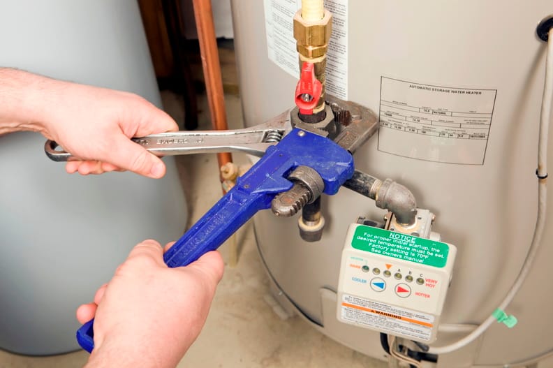 Plumber repairing a water heater valve in Ruskin